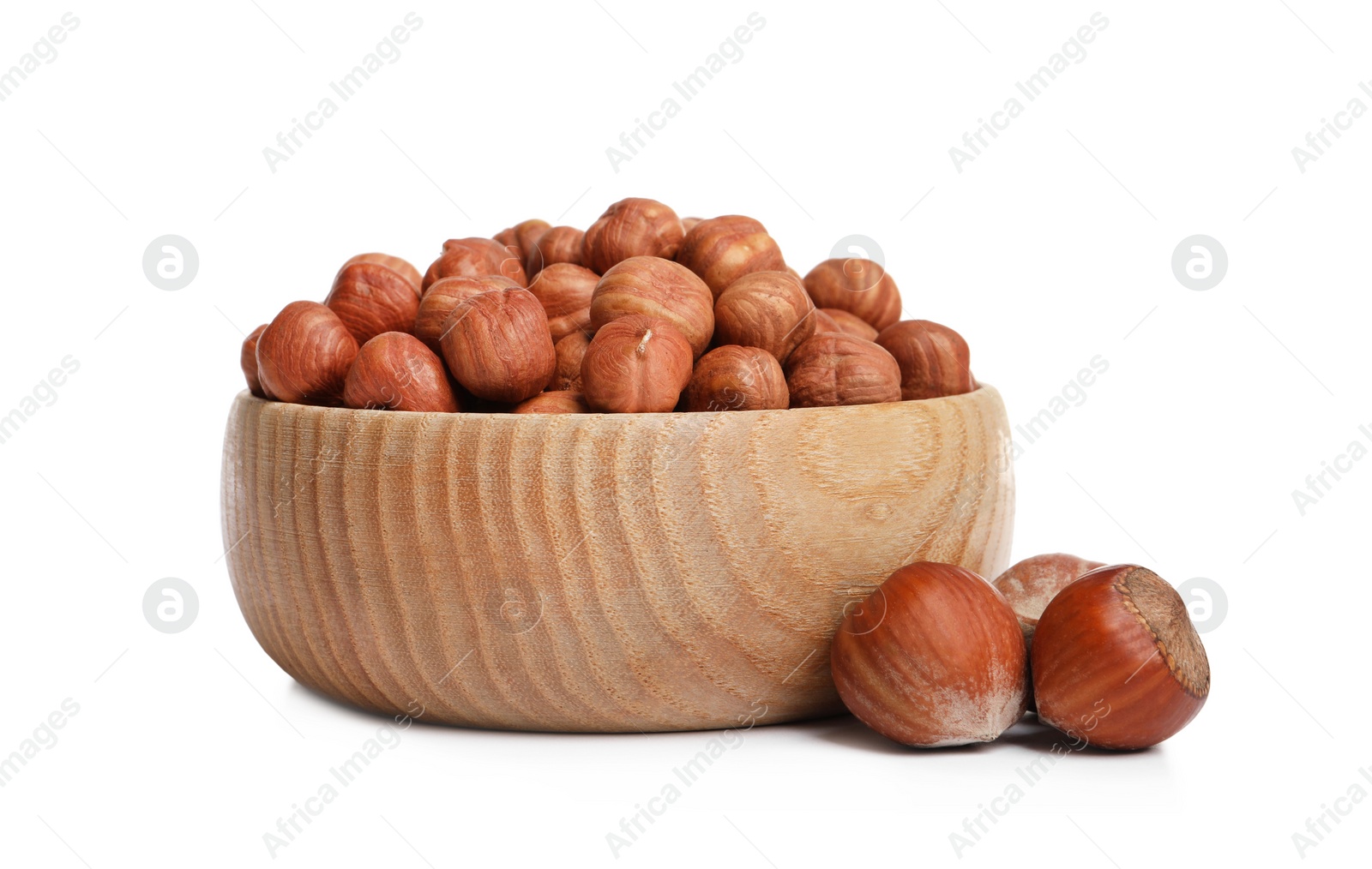 Photo of Bowl with tasty organic hazelnuts on white background