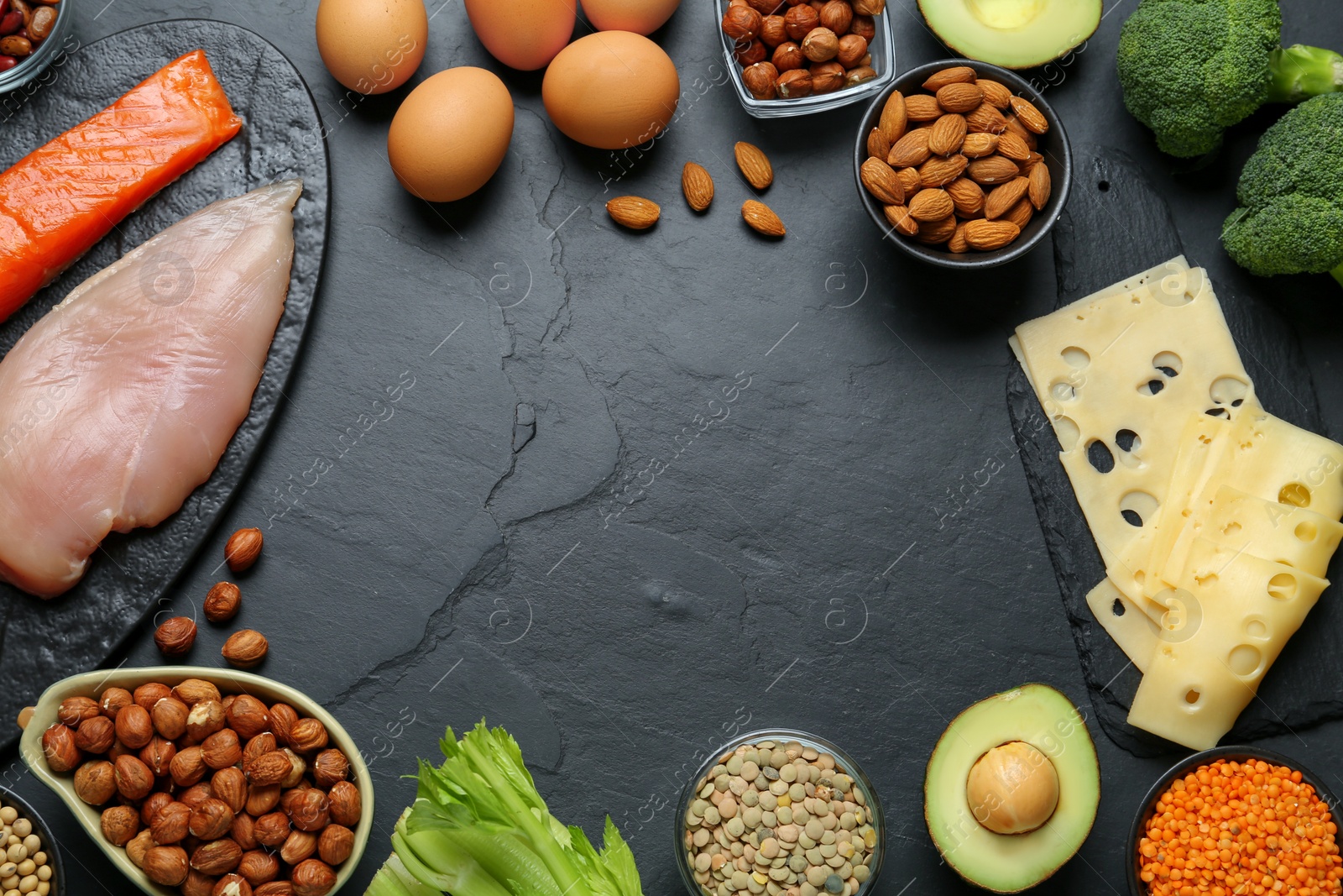 Photo of Frame with different fresh products on black table, flat lay and space for text. Sources of essential amino acids