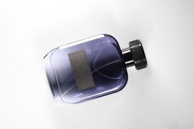 Photo of Luxury men`s perfume in bottle on white background, top view