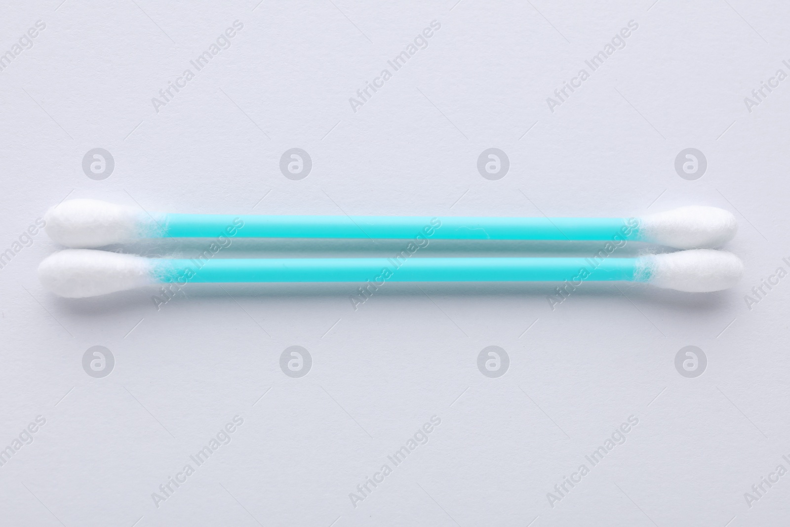 Photo of Clean cotton buds on white background, top view. Hygienic accessory