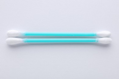 Photo of Clean cotton buds on white background, top view. Hygienic accessory