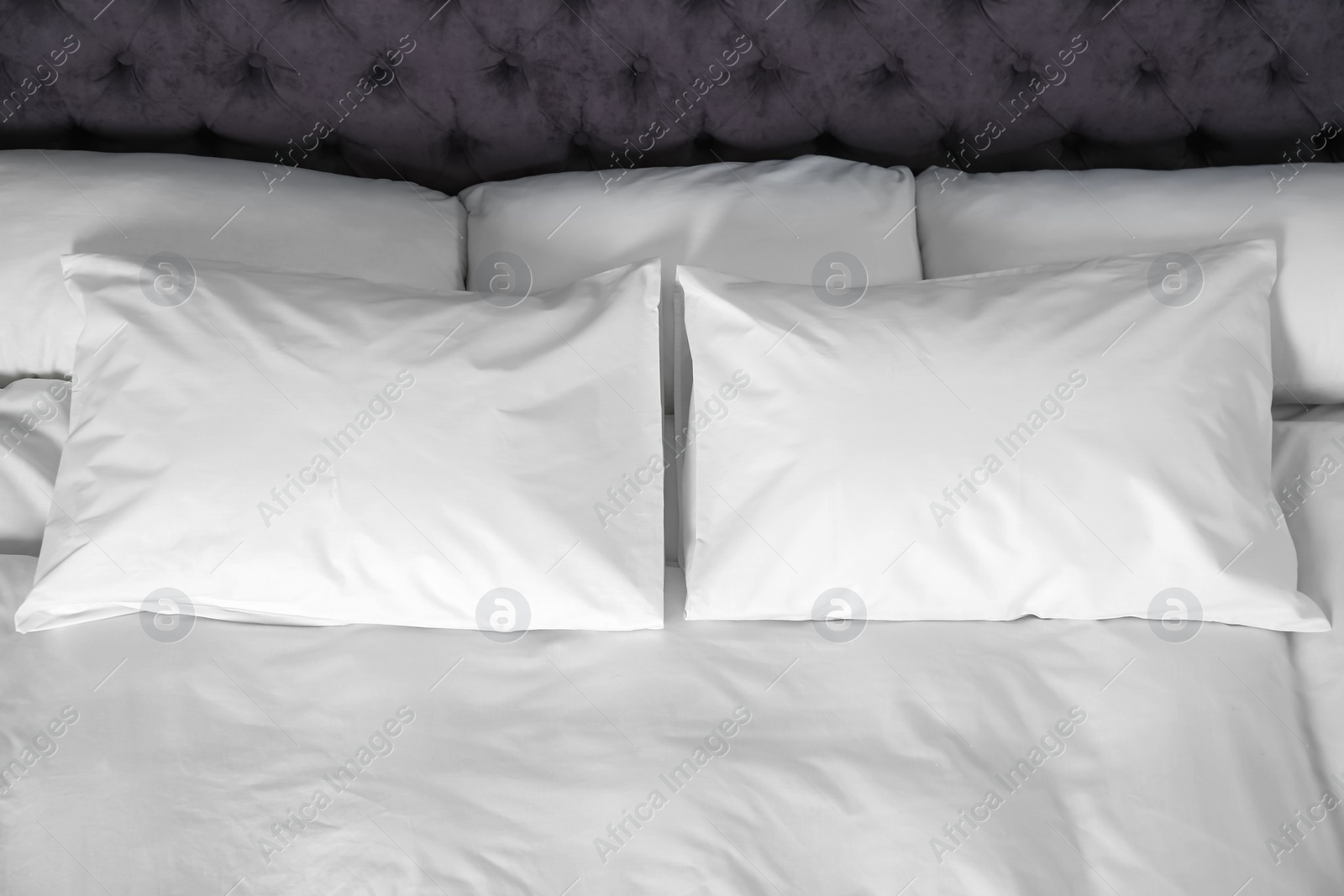 Photo of Bed with soft fluffy pillows at home, above view