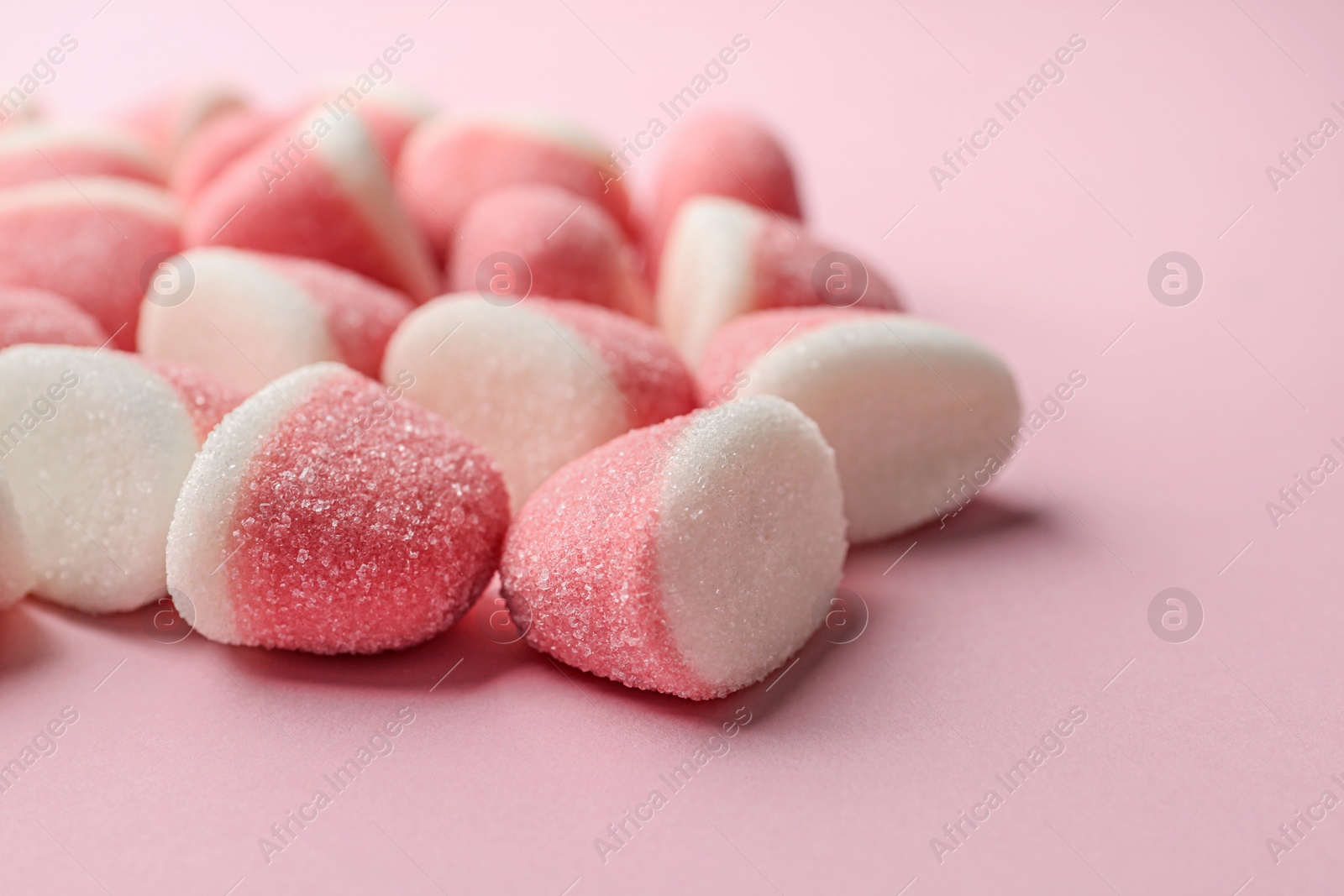 Photo of Closeup of sweet jelly candies on pink background