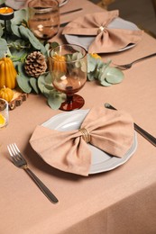 Photo of Autumn table setting with eucalyptus branches and pumpkins