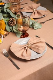 Autumn table setting with eucalyptus branches and pumpkins