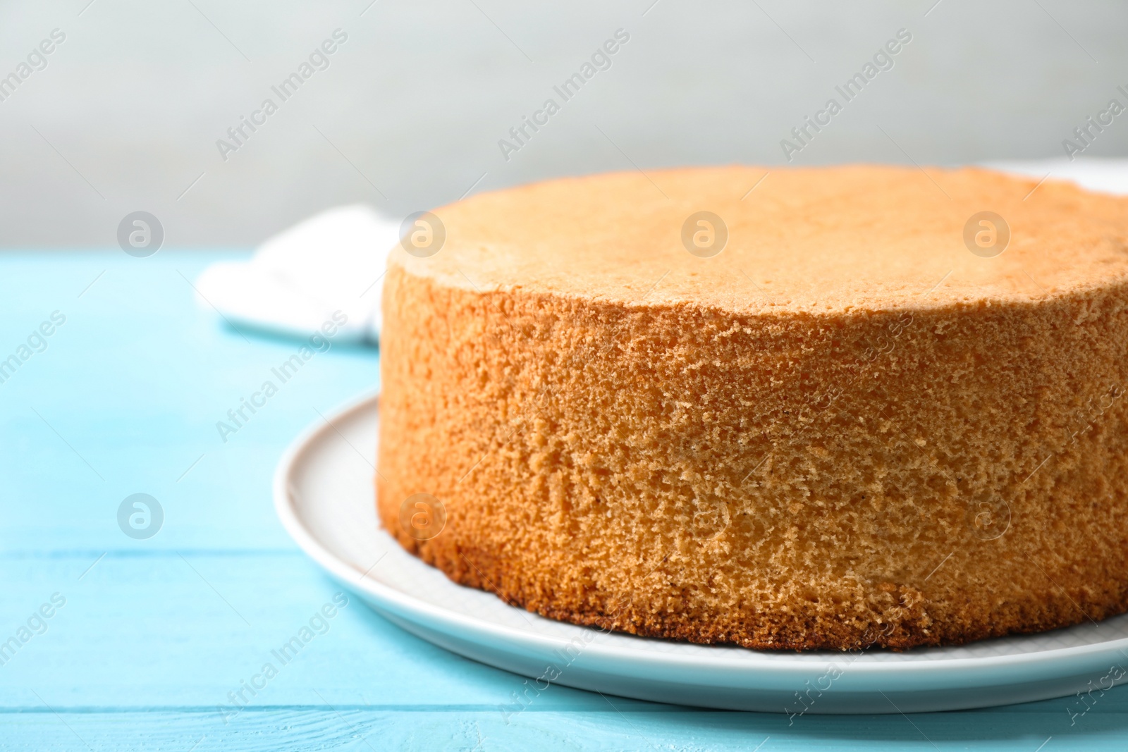 Photo of Delicious fresh homemade cake on light blue wooden table, closeup