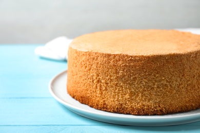 Photo of Delicious fresh homemade cake on light blue wooden table, closeup