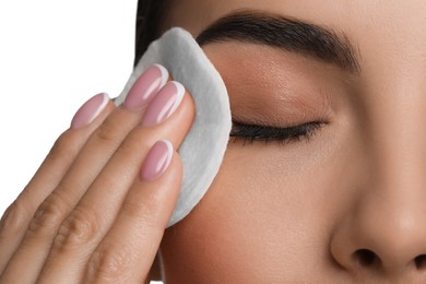 Photo of Beautiful woman removing makeup with cotton pad on white background, closeup