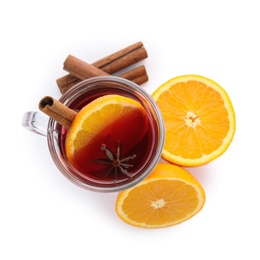 Photo of Glass cup of mulled wine, fresh orange and cinnamon sticks isolated on white, top view