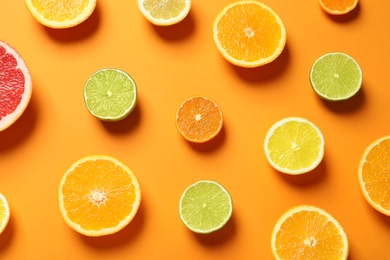 Photo of Different citrus fruits on color background, flat lay