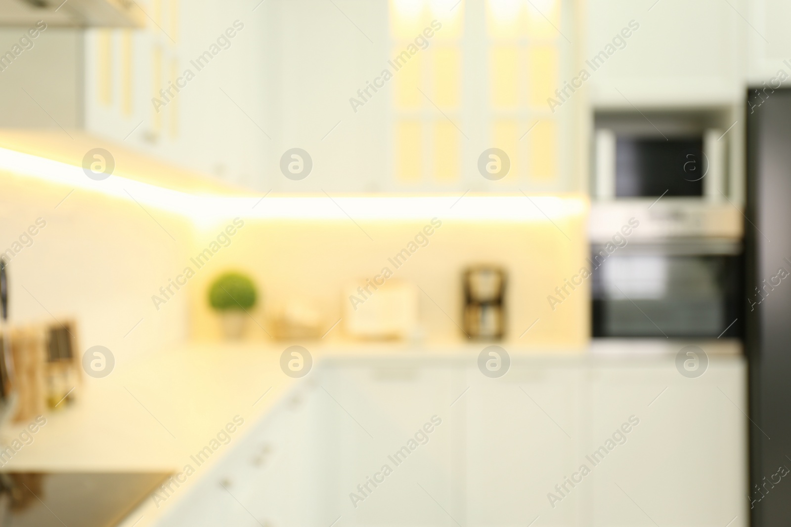 Photo of Blurred view of modern kitchen interior with stylish furniture