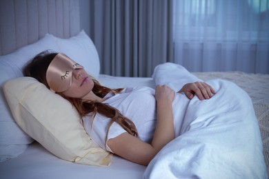 Image of Young woman with mask sleeping in bed. Tip for manage sleep deprivation