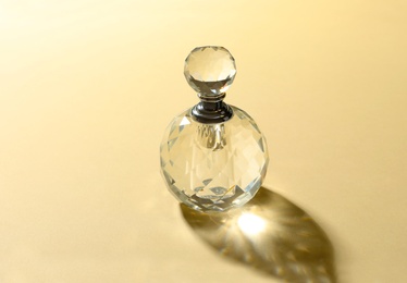 Photo of Elegant bottle of perfume on beige background