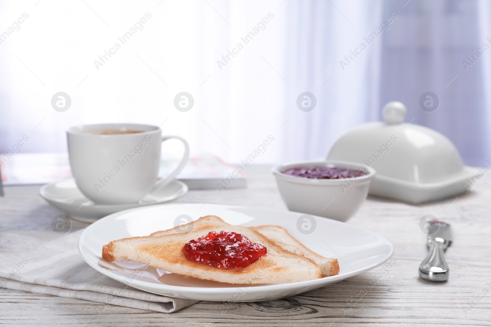 Photo of Toasts with sweet jam on wooden table