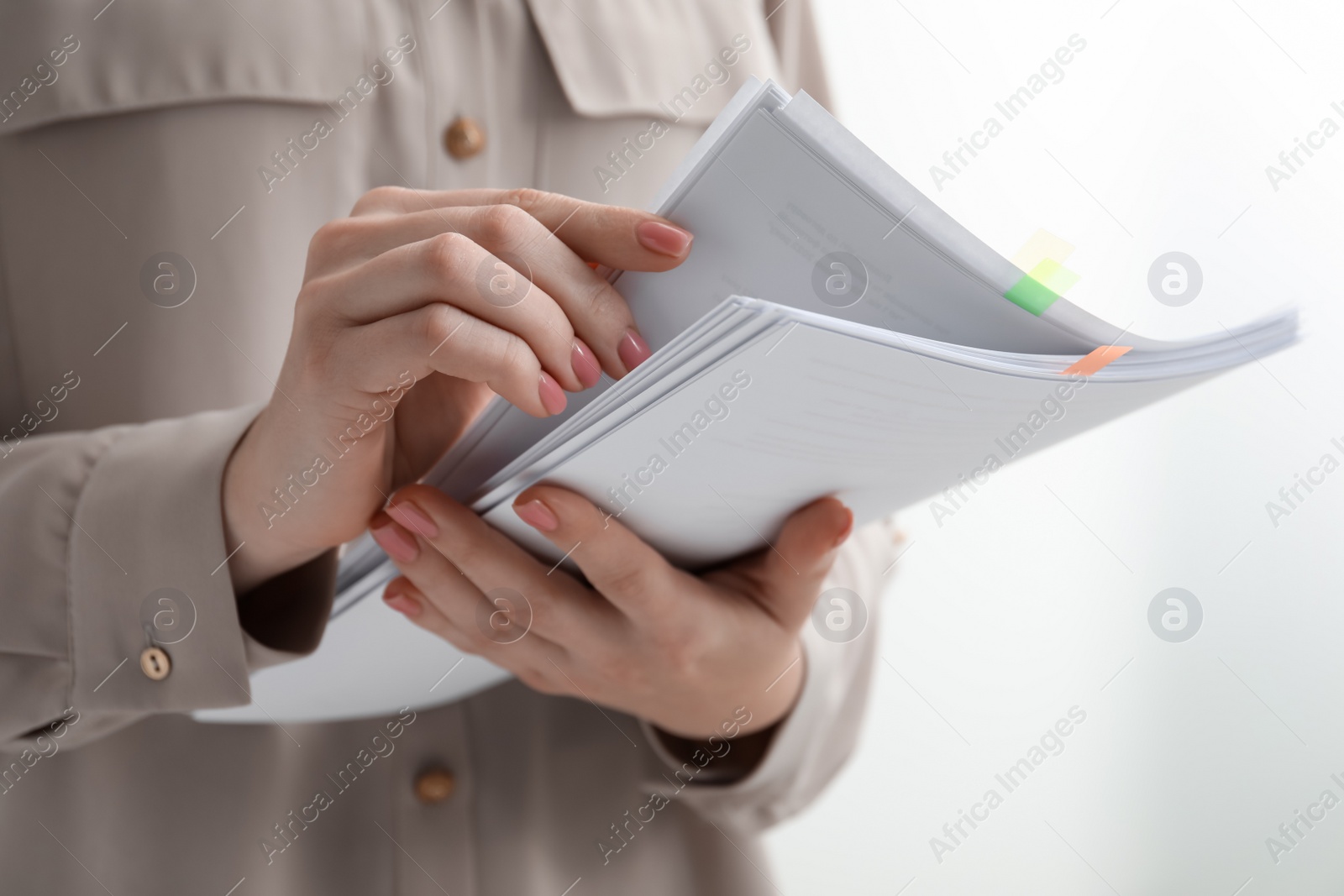 Photo of Woman stacking documents on white background, closeup