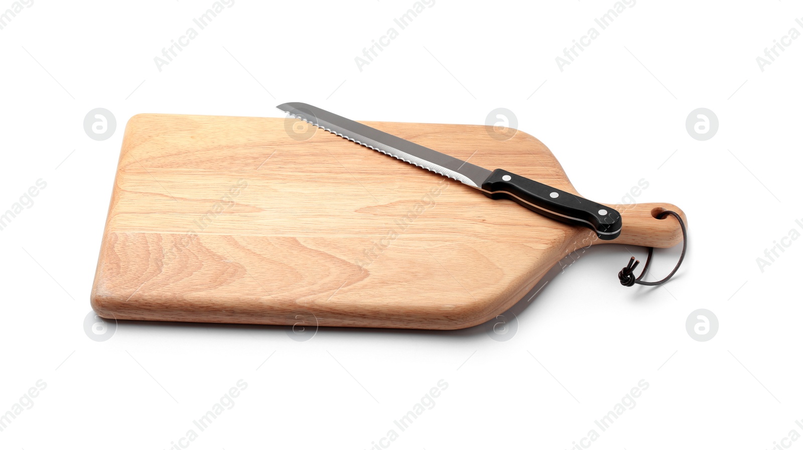 Photo of Stainless steel bread knife with plastic handle on board against white background