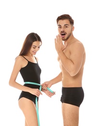 Photo of Fit people with measuring tape on white background. Weight loss