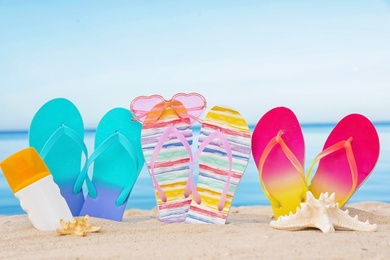 Photo of Sandy beach with different beach accessories near sea. Summer vacation