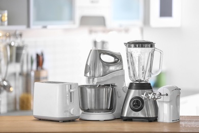 Photo of Different modern kitchen appliances on table indoors. Interior element