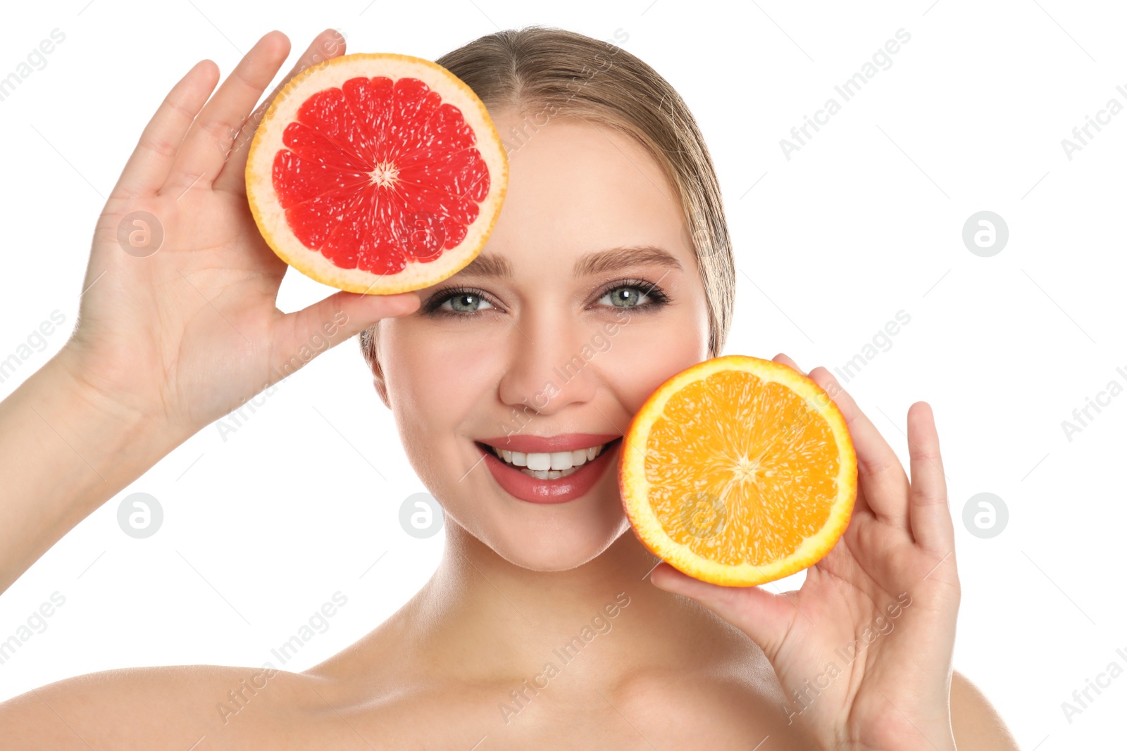 Photo of Young woman with cut orange and grapefruit on white background. Vitamin rich food