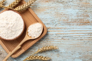 Photo of Organic wheat flour on light wooden table, flat lay. Space for text