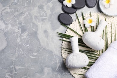 Spa bags, stones and orchid flowers on light gray marble table, flat lay. Space for text