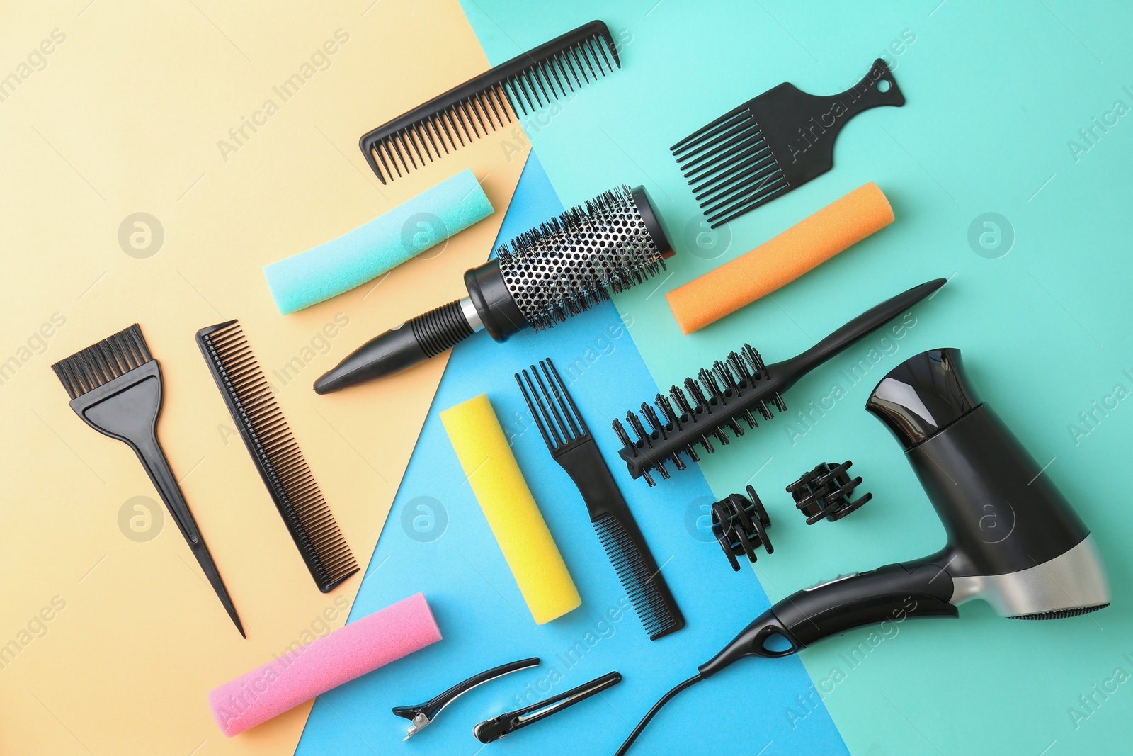 Photo of Flat lay composition with professional hairdresser tools on color background