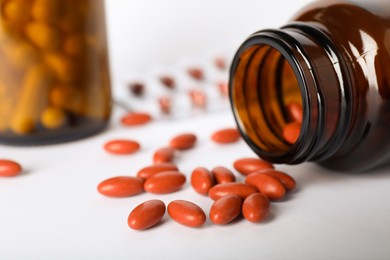 Bottle with pills on light background, closeup and space for text. Anemia treatment