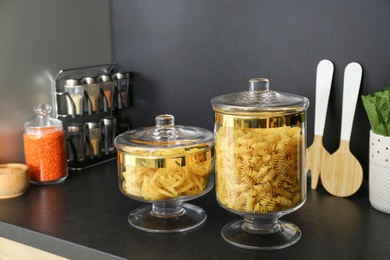 Photo of Products in modern kitchen glass containers on black table