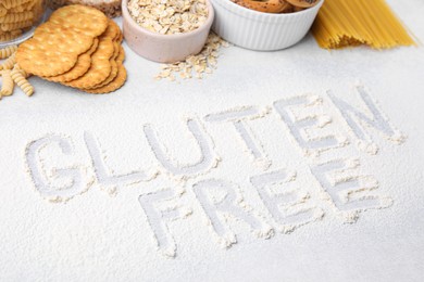 Photo of Different products and phrase Gluten free written with flour on light grey table
