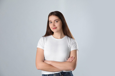 Portrait of young woman on light background