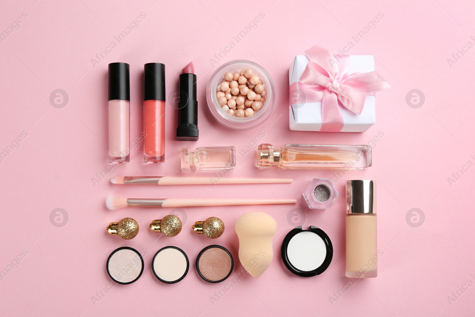 Photo of Flat lay composition with decorative cosmetic products on pink background. Winter care