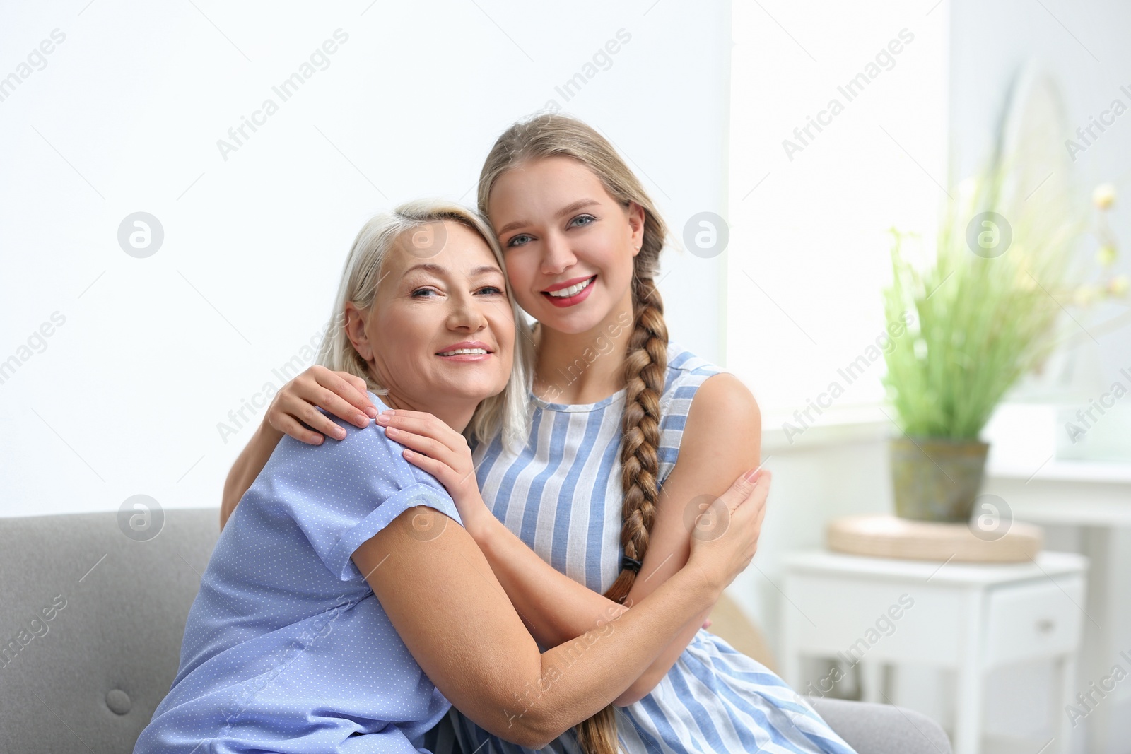 Photo of Mother and her adult daughter spending time together at home