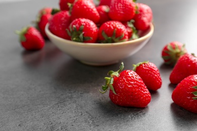 Ripe red strawberries on grey table, closeup