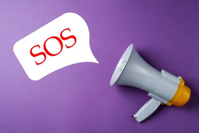 Image of Electronic megaphone and word SOS on violet background. Asking for help