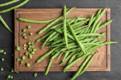 Fresh green beans on black table, flat lay