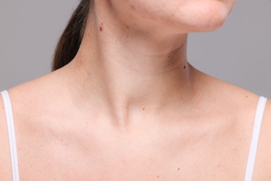 Photo of Closeup view of woman with normal skin on grey background