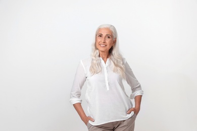 Portrait of beautiful mature woman on light background