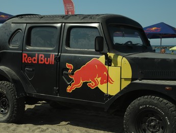 SENIGALLIA, ITALY - JULY 22, 2022: Red Bull Jeep on beach. Car presentation