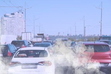 Environmental pollution. Air contaminated with fumes in city. Cars surrounded by exhaust on road