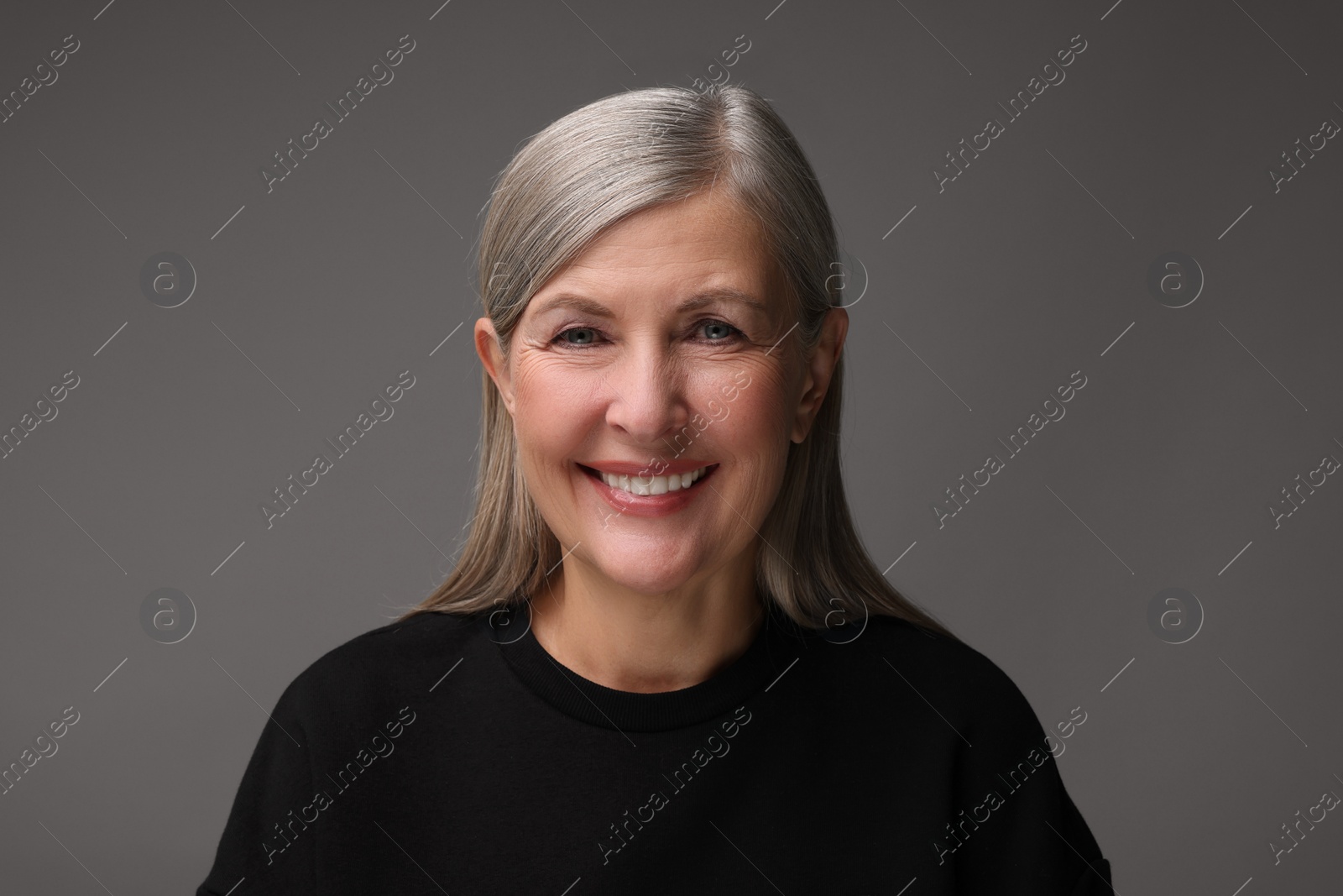 Photo of Personality concept. Portrait of emotional woman on gray background