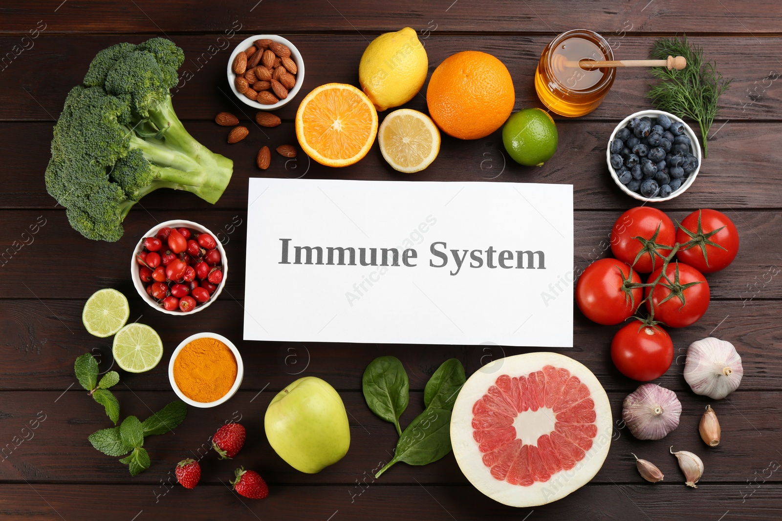Photo of Card with phrase Immune System and fresh products on wooden table, flat lay