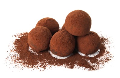 Delicious chocolate truffles powdered with cocoa on white background