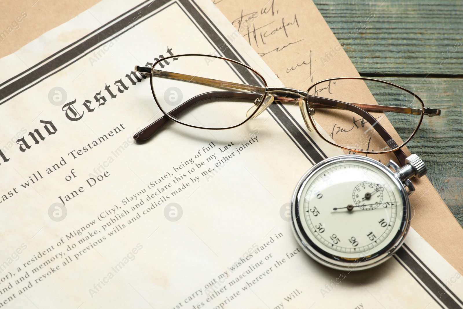 Photo of Last Will and Testament, pocket watch and glasses on rustic wooden table, closeup