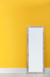 Photo of Large stylish mirror in empty room