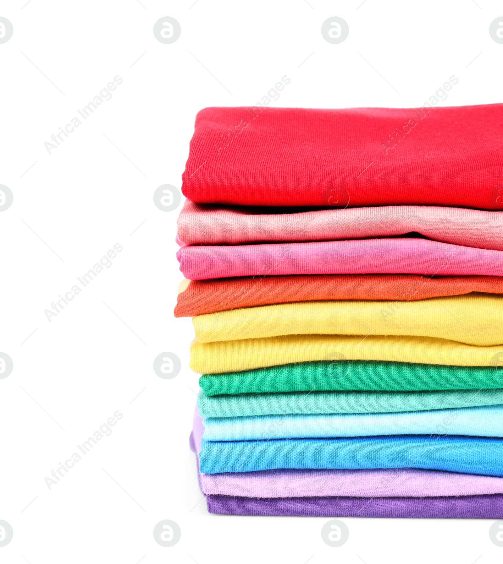 Photo of Stack of colorful t-shirts on white background