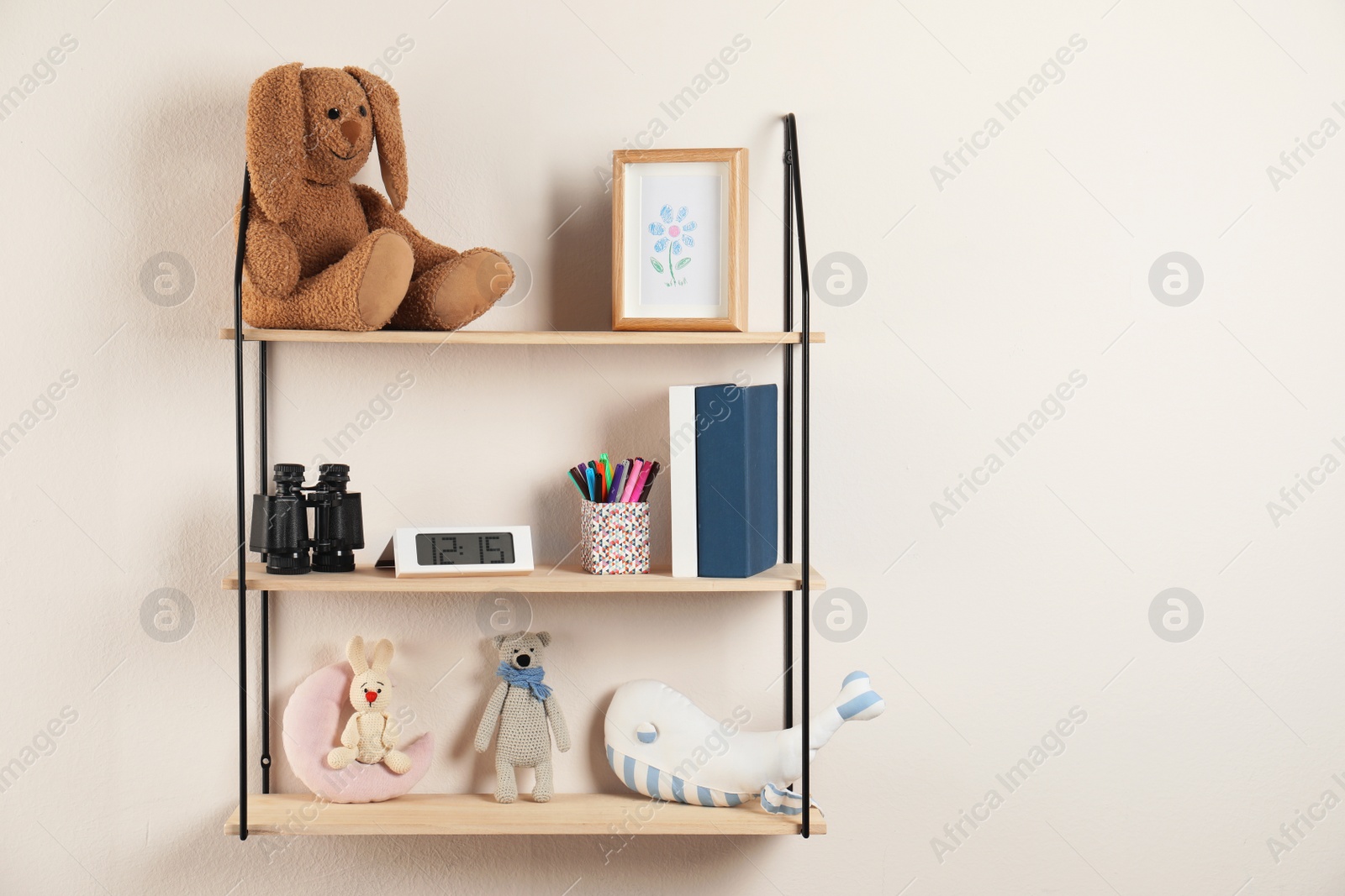 Photo of Shelves with toys and kids stuff in child room. Space for text
