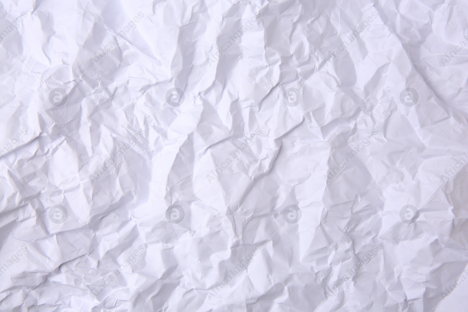 Photo of Sheet of crumpled paper white as background, top view