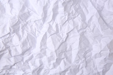 Sheet of crumpled paper white as background, top view