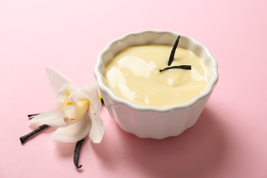 Photo of Vanilla pudding, sticks and flower on color background